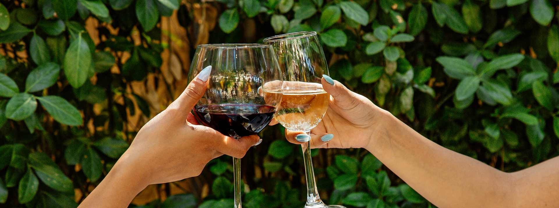 Two glasses of wine worn to drink outside.